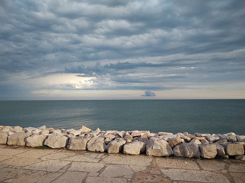 a panoramic view of the waterfront cliff of caorle venice and sea horizon after a storm