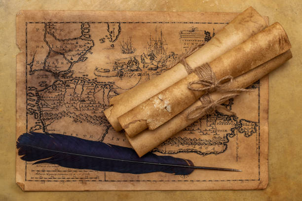 old map, paper scrolls, raven feather for writing. vintage image - writing manuscript ancient postcard imagens e fotografias de stock