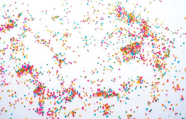 Sugar sprinkle dots on white background stock photo