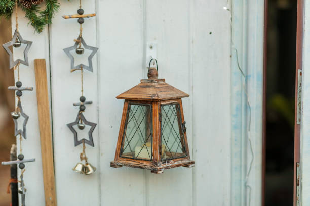 Wooden lantern and stars on a blue wall. Pendants.