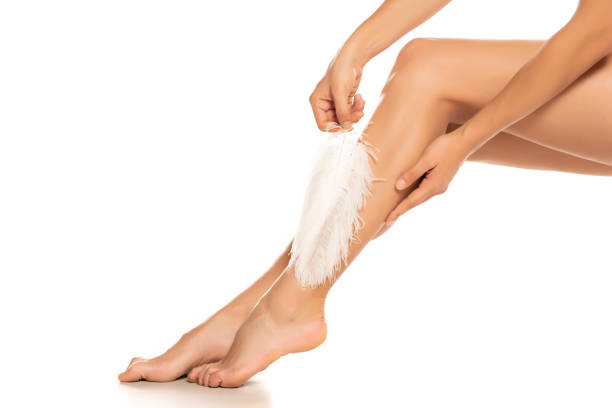 istock Woman touches her legs with white feather 1277383403