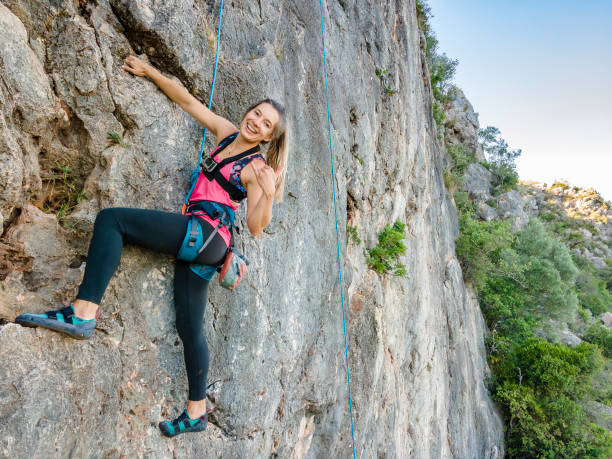 istock A woman in harness climbing a steep rock 1277383999