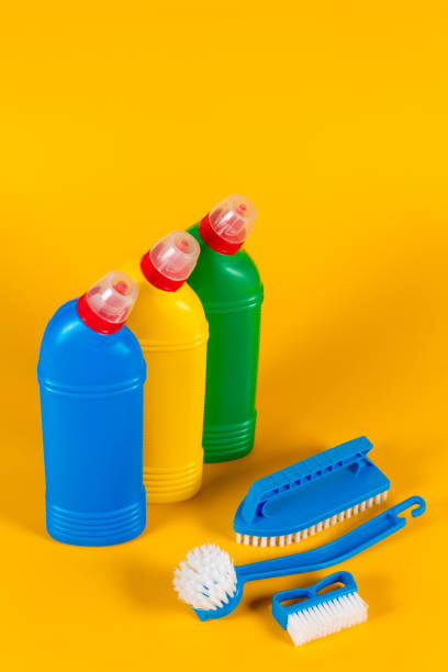 istock Bottle with detergent powder and brushes on yellow background, space for text 1277384118