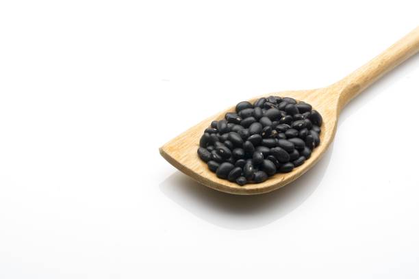 istock Wooden ladle with black beans 1277384444