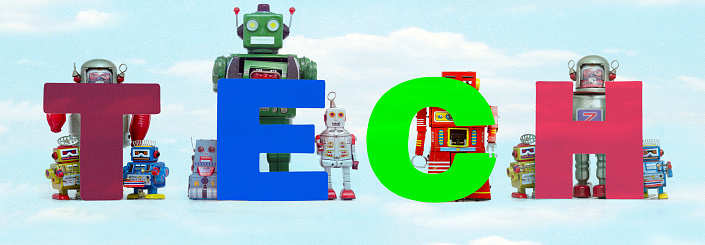 retro tin robot toys hold up the word  TECH  cloud