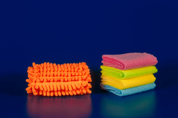 Auto service workers polishing (cleaning) car with yellow sponge , car detailing or valeting concept