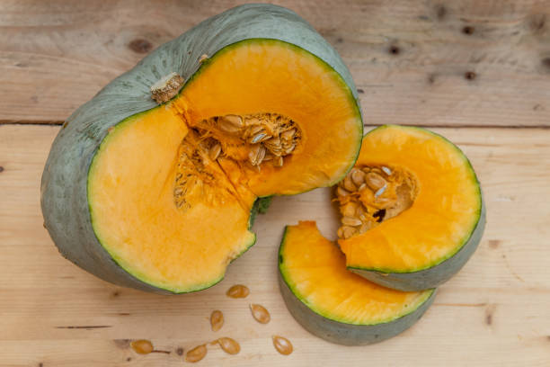 istock Big orange open pumpkin on a wooden table 1277385877