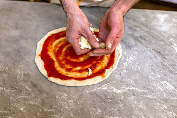 istock Cooking pizza. Pancake for pizza smeared with ketchup 1277386231