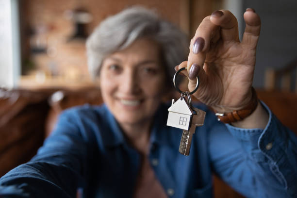 Excited senior woman show new house keys Close up blurred of happy elderly 60s grandmother show keys excited about house bank mortgage or lease, smiling mature woman tenant renter overjoyed to be home owner, relocation, rental concept reduction looking at camera finance business stock pictures, royalty-free photos & images