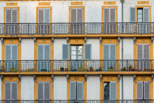 istock Light blue windows in yellow frames in the building in Constitution Square built in 1817 located San Sebastian in Spain 1277387233