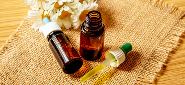 istock chamomile extract in small shoes on burlap. selective focus 1277387350