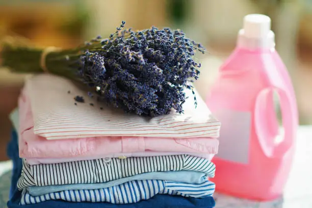 Photo of pile of clothes, softener and bunch of lavender