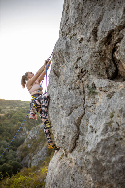 istock Young woman climbing on a limestone wall 1277390660