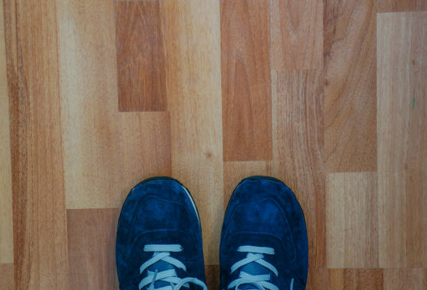 istock blue sneakers on a wooden floor 1277394840