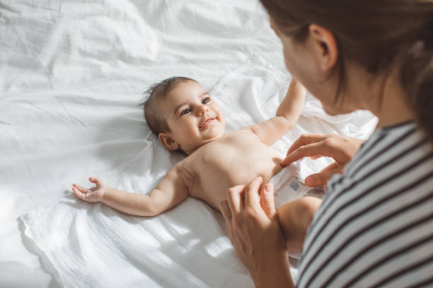 Mother and baby Mother and baby girl in bedroom. Diaper stock pictures, royalty-free photos & images