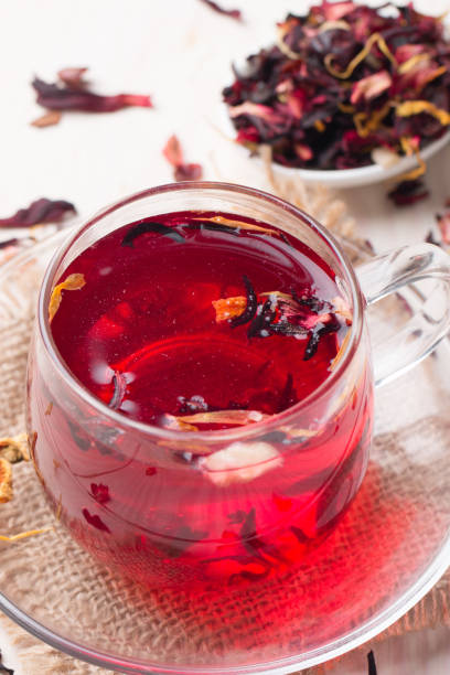 istock Cup of fresh red tea on wooden background 1277396334