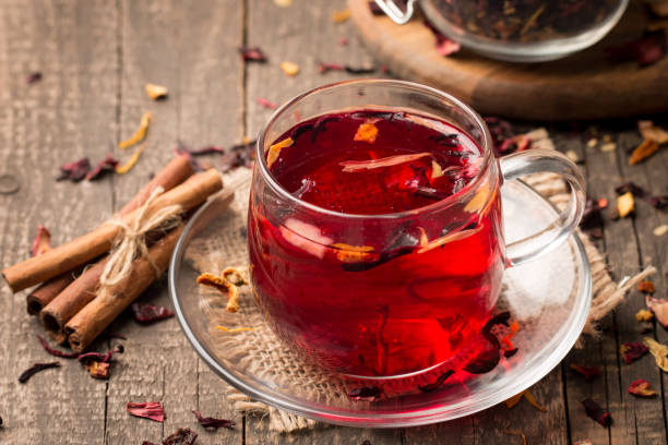 istock Cup of fresh red tea on wooden background 1277396373