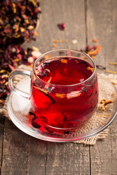 istock Cup of fresh red tea on wooden background 1277396389