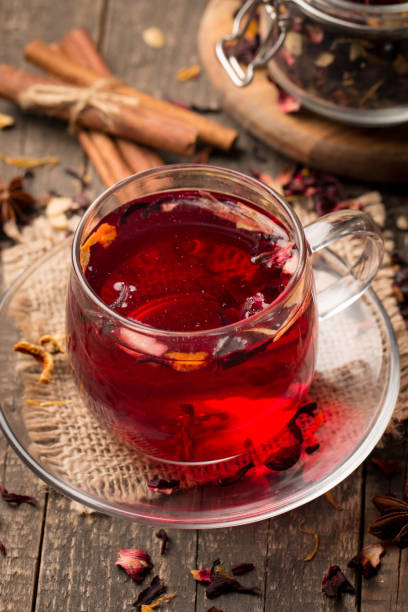 istock Cup of fresh red tea on wooden background 1277396422