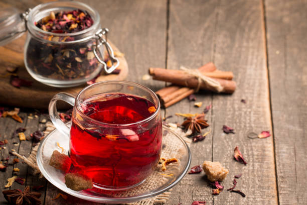 istock Cup of fresh red tea on wooden background 1277396442