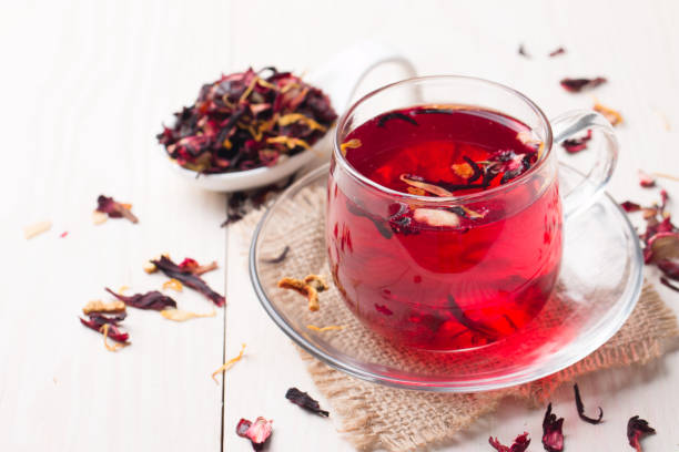 istock Cup of fresh red tea on wooden background 1277396454