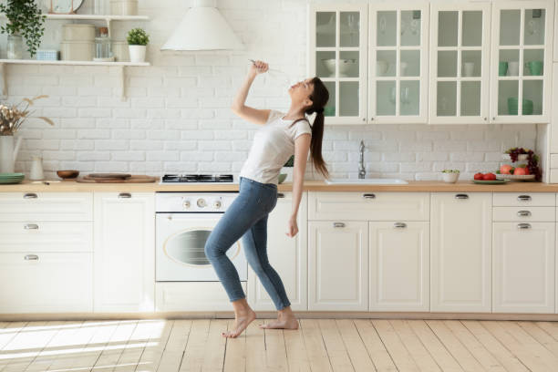 istock Young woman having fun in cozy kitchen 1277398409