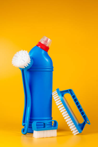 istock Bottle with detergent powder and brushes on yellow background, space for text 1277399340