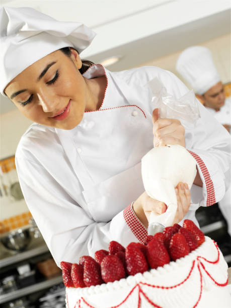 istock Female Chef Working On Strawberry Cake 1277400557