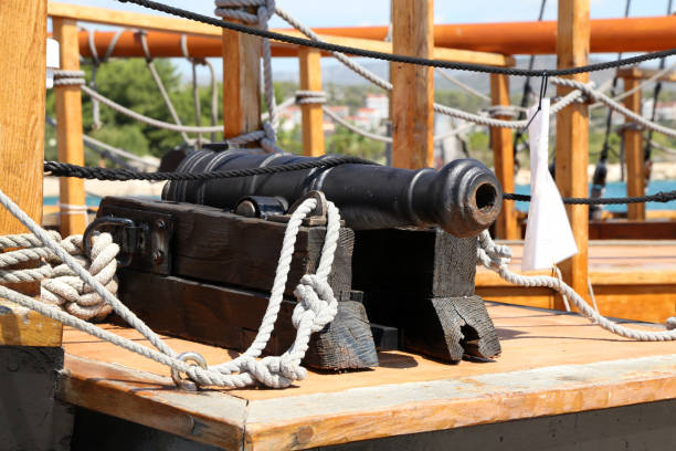 istock Old medieval cannon on the deck of a pirate ship 1277402541