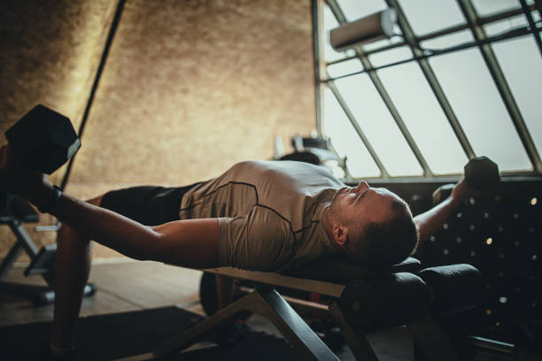 istock One muscular man working out with dumbbells in the gym 1277402721