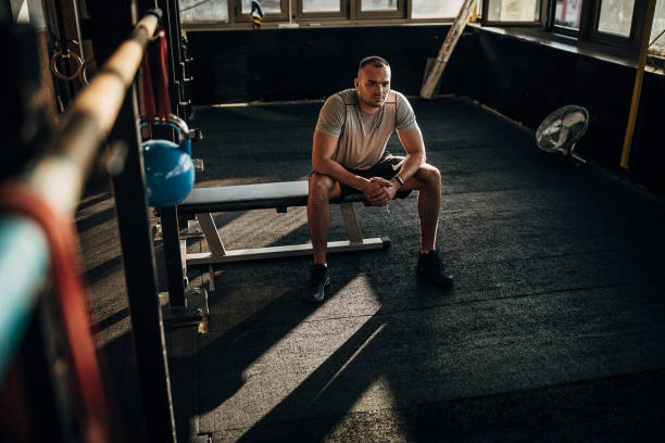 istock One young athletic man resting on bench press in the gym 1277403893