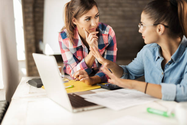 istock Two female freelance workers discussing in the office 1277405272