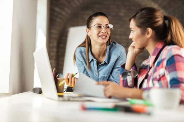 istock Two female freelance workers discussing in the office 1277405363