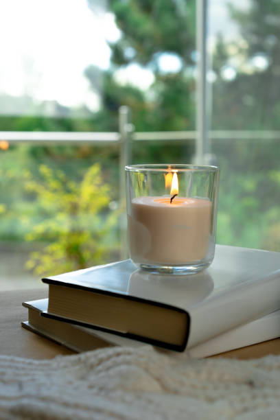istock Candle in front of window 1277405477
