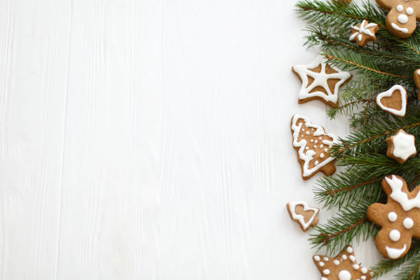 istock Christmas  greeting card flat lay with gingerbread cookies and fir branches, space for text 1277405536