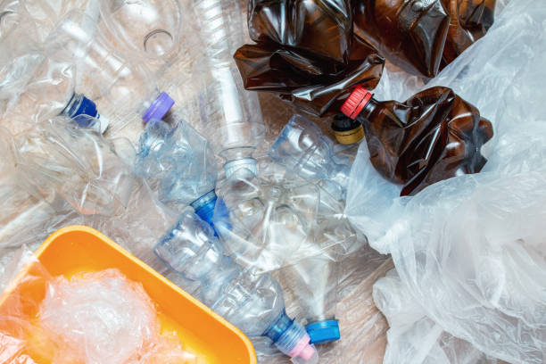 istock Lot of used plastic, crumpled empty bottles, packets, plastic orange dish, diaper, pollution recycle eco concept background close up selective focus 1277406063