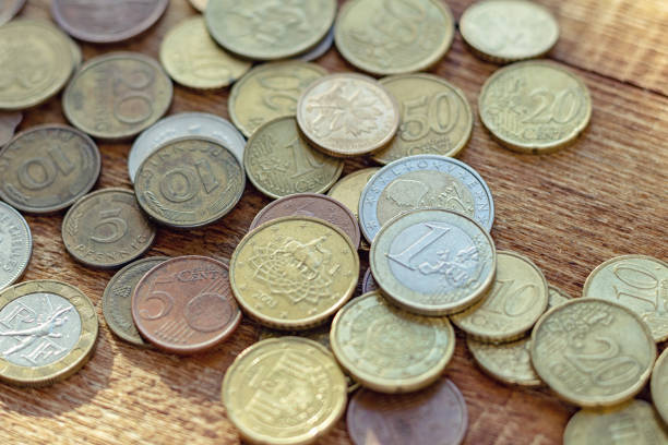 istock coins old rusty brass euro Seychelles Bulgaria China Germany pile pack heap stack on a wooden background finance economy investment savings concept mock up selective focus close up 1277406846