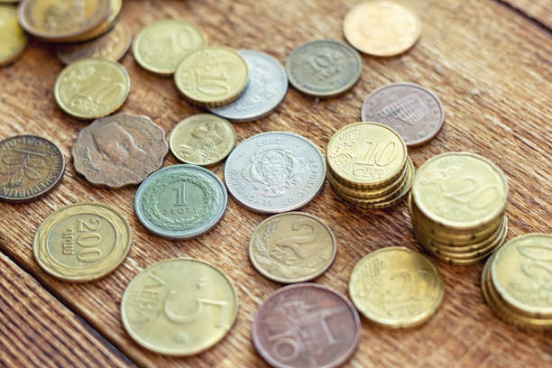 istock coins old rusty brass euro Seychelles Bulgaria China Germany pile pack heap stack on a wooden background finance economy investment savings concept mock up selective focus close up 1277406855
