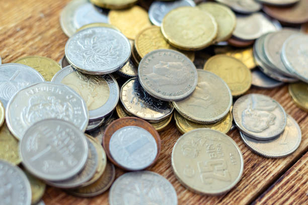 istock coins old rusty brass euro Seychelles Bulgaria China Germany pile pack heap stack on a wooden background finance economy investment savings concept mock up selective focus close up 1277406867