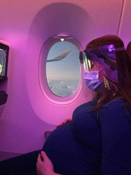 istock Pregnant woman wearing protective mask during flight. 1277407010