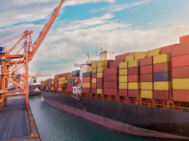 istock Aerial view of industrial port with containers and container ship. 1277409021
