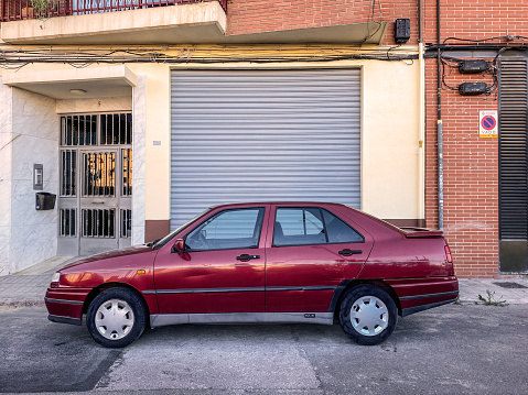 Valencia, Spain - September 27, 2020: A red Seat car model Toledo parked in the street. It was produced by the Spanish manufacturer from 1991 to 2018