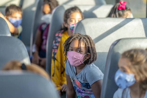 istock Elementary school children wearing masks on a bus 1277409981