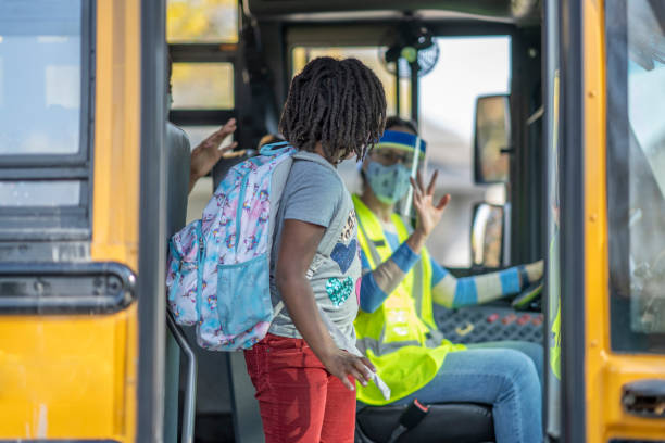 istock Masked school children getting off the bus 1277410011