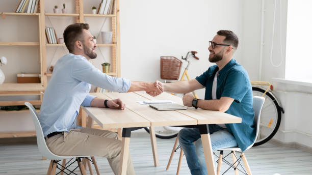 istock Smiling hr manager wearing glasses shaking candidate hand on interview 1277410286