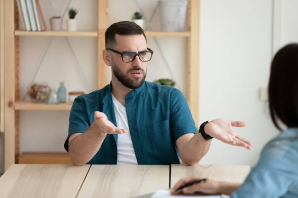 istock Dissatisfied client young man wearing glasses arguing with manager 1277410300