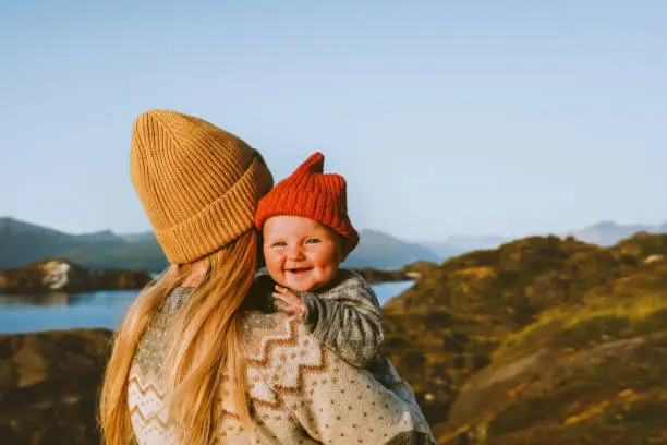 Photo of Cute baby and mother walking outdoor travel family vacations lifestyle mom and smiling child together Mothers day holiday