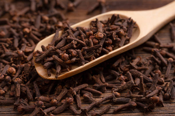 istock Carnation seeds close up. Fragrant clove seeds in a spoon. 1277411652