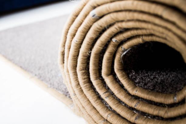istock The rolled carpet lies on the white floor. 1277413977