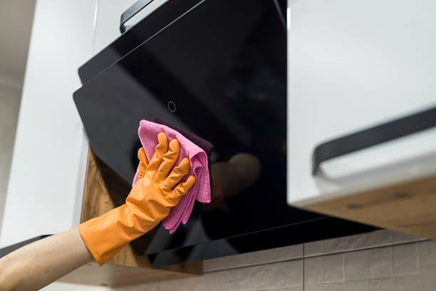 istock Cleaning kitchen. Female hand washing kitchen hood with sponge. 1277414625